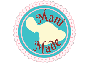 A circular logo with a scalloped edge. The outer ring is light pink with polka dots, followed by a turquoise ring. Inside, there's an ivory silhouette of the island of Maui. The words "Maui Made" are written in red, stylized font, curving around the island silhouette—perfect for any Maui bakery delights.