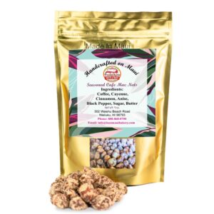 A gold resealable bag labeled "Made In Maui" contains Seasoned Cafe Macadamia Nuts, perfect for any bakery treat. The label lists ingredients: coffee, cayenne, cinnamon, anise, black pepper, sugar, and butter. Contact details are included. A sample of the macadamia nuts is displayed in front of the bag.